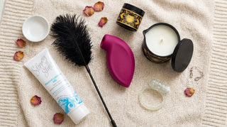 Flatlay of The Essence of Desire Ultimate Couples Starter Kit with intimate accessories and products for couples.
